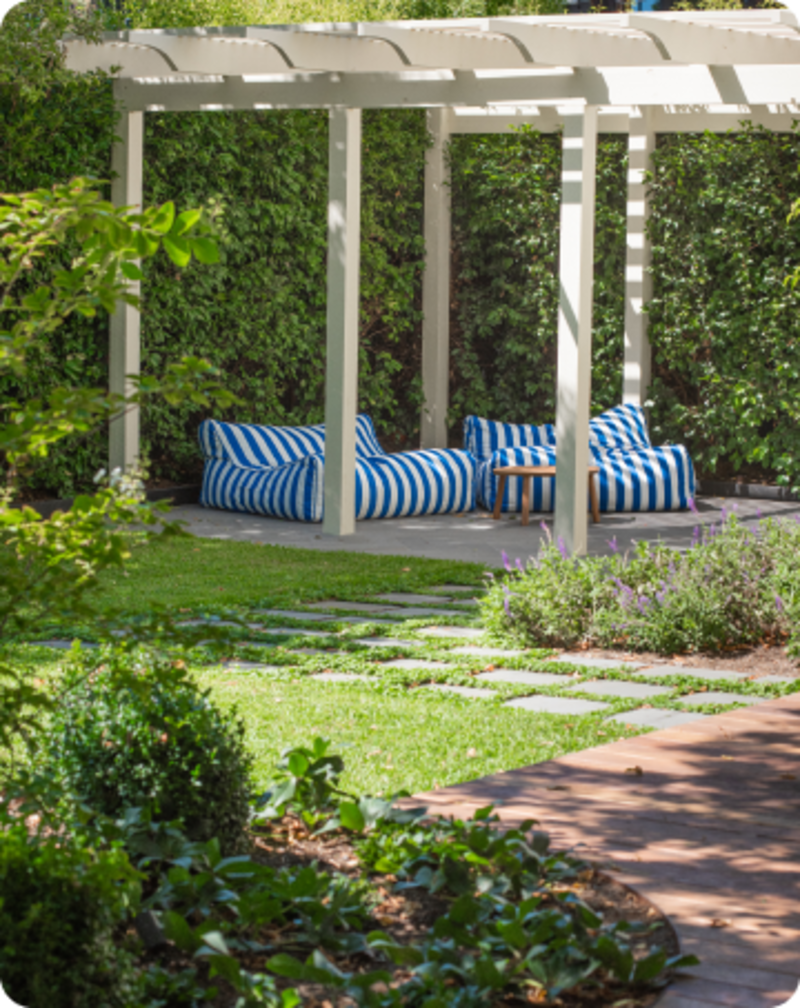 Pergola with shade battens and seating area in Sandringham garden