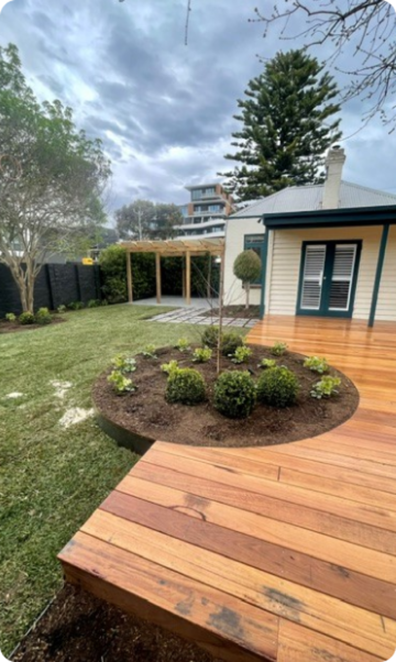Completed Bay Road Sandringham garden with lawn, deck and curved garden bed