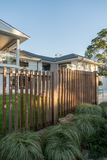ornamental grasses softening a pool fence